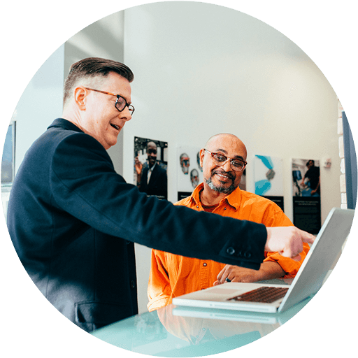 2 businees-men-talking-and-looking-laptop