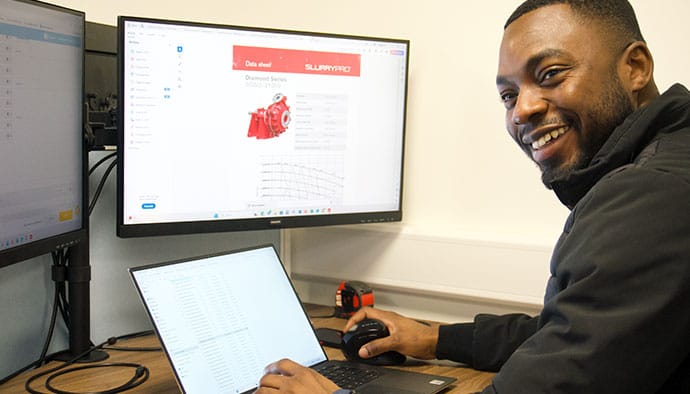 employee-sat-at-computer-smiling