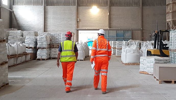 engineers-and-client-walking-through-factory